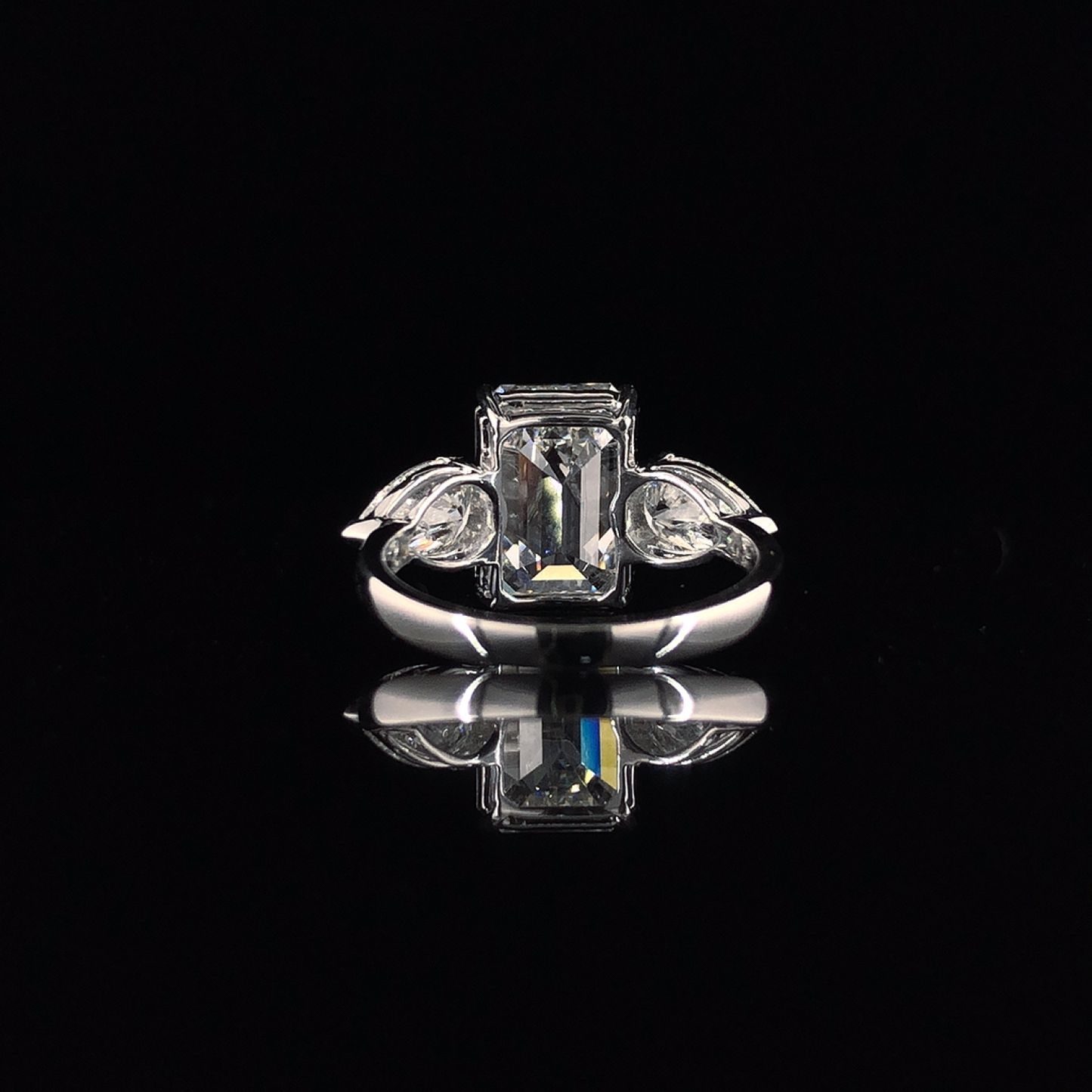 Emerald And Pear Cut Diamond Halo Three Stone Engagement Ring